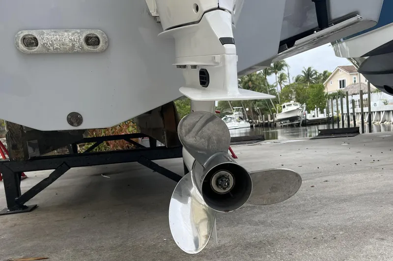 Slide: The Image of 2023 Robalo R302 Center Console boat propeller on a trailer near a marina. - 15