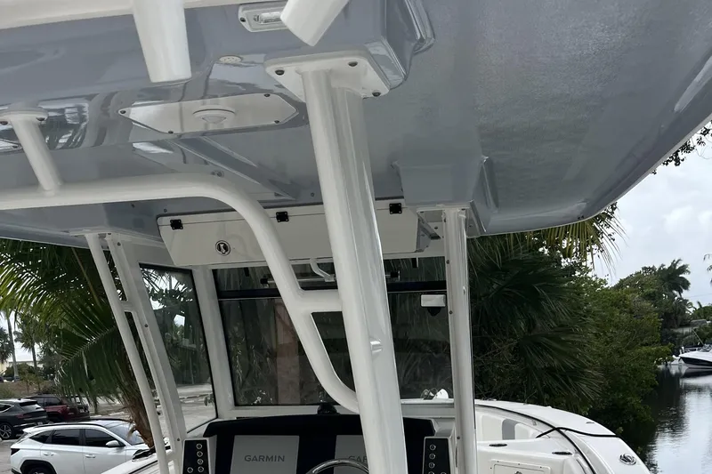 Slide: The Image of 2023 Robalo R302 Center Console boat interior with Garmin electronics and overhead structure. - 22