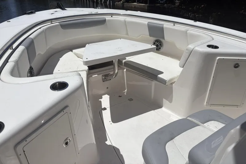 Slide: The Image of 2023 Robalo R302 Center Console boat interior with seating and table. - 7