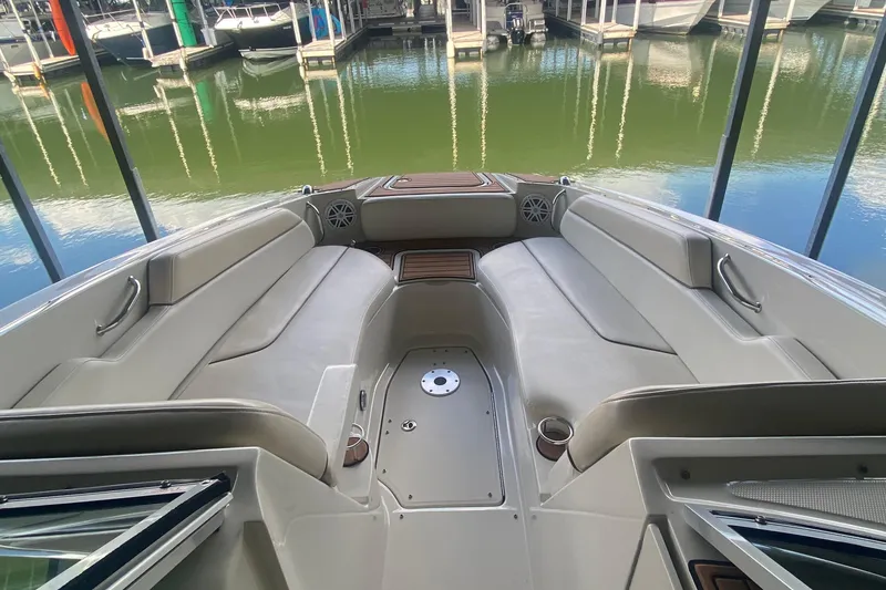 Slide: The Image of 2008 Sea Ray 290 Sundeck interior with spacious seating, docked at marina. - 13
