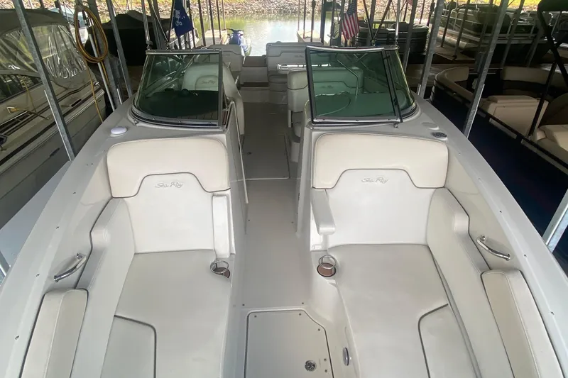 Slide: The Image of 2008 Sea Ray 290 Sundeck interior with white seating and cup holders. - 14
