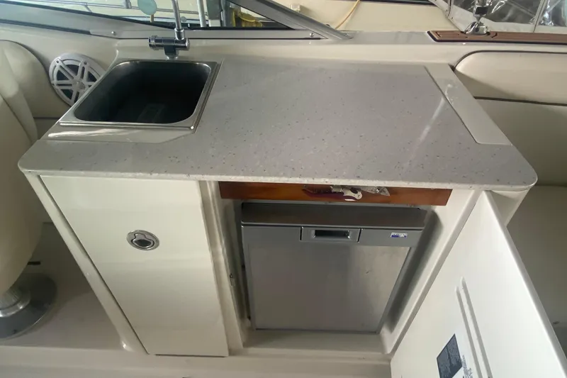 Slide: The Image of 2008 Sea Ray 290 Sundeck kitchenette with sink and mini fridge. - 15
