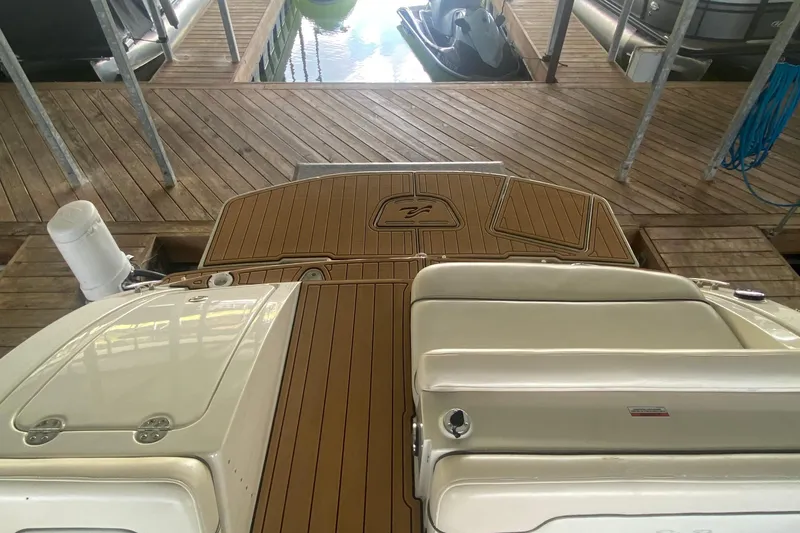 Slide: The Image of 2008 Sea Ray 290 Sundeck boat docked, featuring a teak-style swim platform. - 16