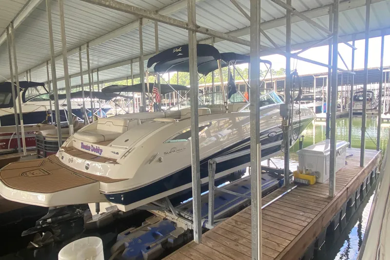 Slide: The Image of 2008 Sea Ray 290 Sundeck boat docked in a covered marina. - 17