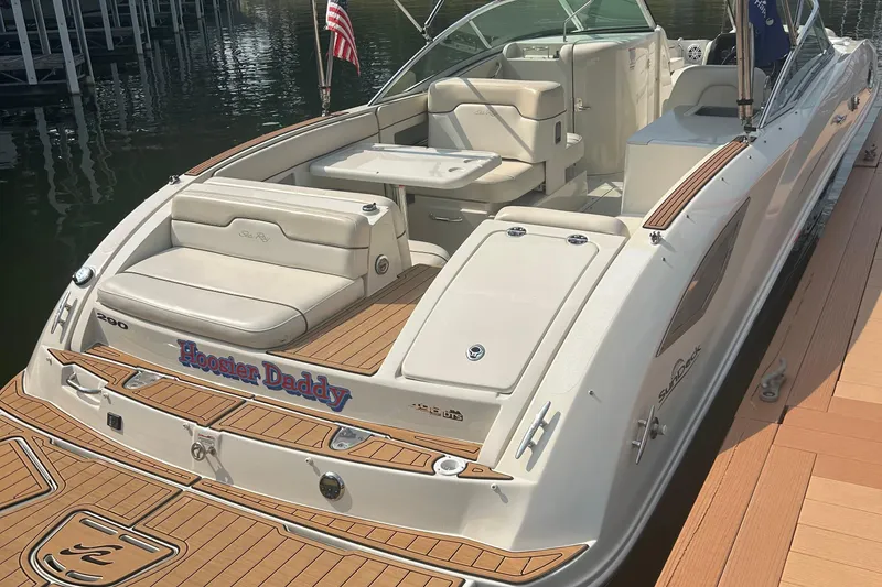 Slide: The Image of 2008 Sea Ray 290 Sundeck boat docked, featuring spacious seating and elegant design. - 4