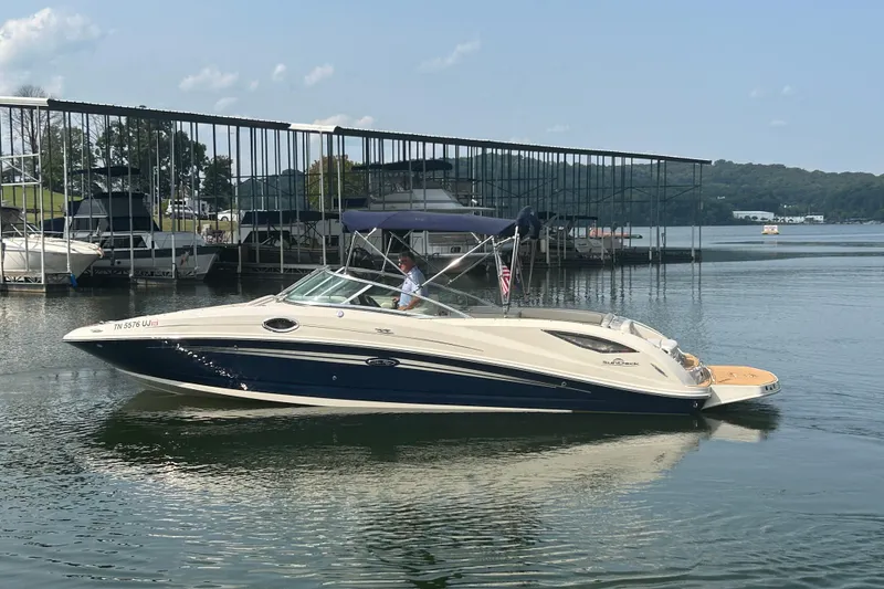 Slide: The Image of 2008 Sea Ray 290 Sundeck boat on calm water near a marina. - 5