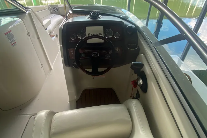 Slide: The Image of 2008 Sea Ray 290 Sundeck cockpit with steering wheel and control panel. - 8