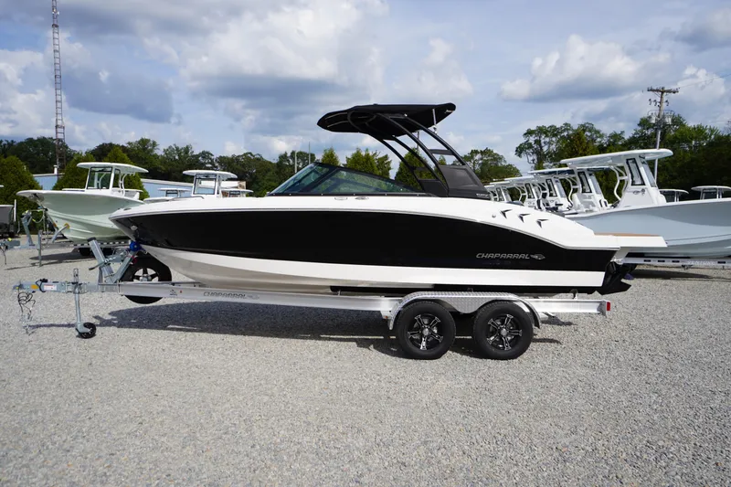 The Image of 2026 Chaparral 21 SSi boat on trailer, black and white design, parked outdoors. - 0