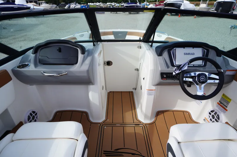 Slide: The Image of 2026 Chaparral 21 SSi boat interior with steering wheel and dashboard controls. - 13