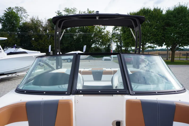 Slide: The Image of 2026 Chaparral 21 SSi boat with sleek windshield and stylish interior design. - 14