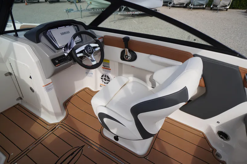 Slide: The Image of 2026 Chaparral 21 SSi boat interior with steering wheel and captain's chair. - 16