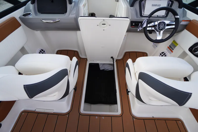 Slide: The Image of 2026 Chaparral 21 SSi boat interior with white seats and brown flooring. - 23