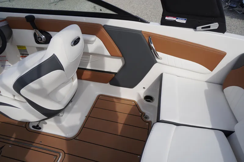 Slide: The Image of 2026 Chaparral 21 SSi boat interior with white and brown seating, modern design. - 24