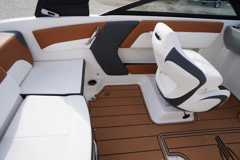 Slide: The Image of 2026 Chaparral 21 SSi boat interior with white and brown seating, modern design. - 25