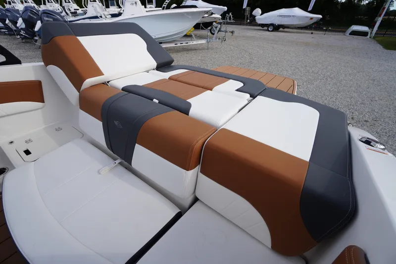 Slide: The Image of 2026 Chaparral 21 SSi boat interior with brown, white, and gray seating. - 29