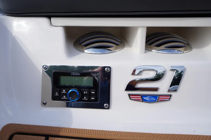 Slide: The Image of 2026 Chaparral 21 SSi boat dashboard with Clarion audio system and chrome detailing. - 36