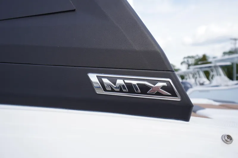 Slide: The Image of Close-up of 2026 Chaparral 21 SSi boat with MTX logo detail. - 4