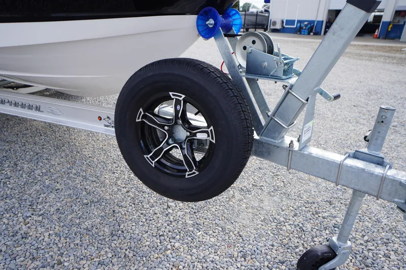 Slide: The Image of Trailer wheel and hitch of 2026 Chaparral 21 SSi boat on gravel surface. - 43