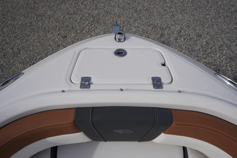 Slide: The Image of 2026 Chaparral 21 SSi boat bow with storage compartment and seating. - 5