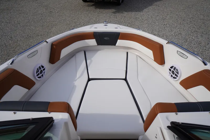 Slide: The Image of 2026 Chaparral 21 SSi boat interior with white and brown seating, featuring speakers. - 6