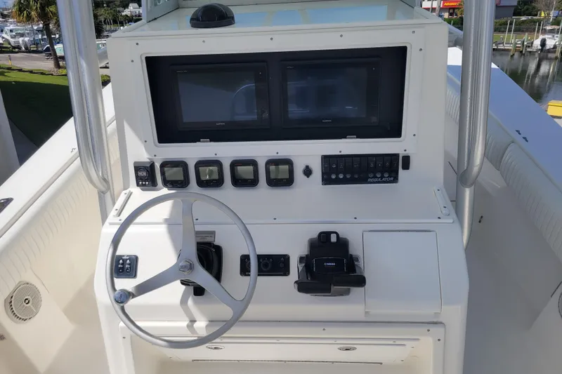 Slide: The Image of 2006 Regulator 29 Forward Seating boat console with steering wheel and navigation controls. - 11
