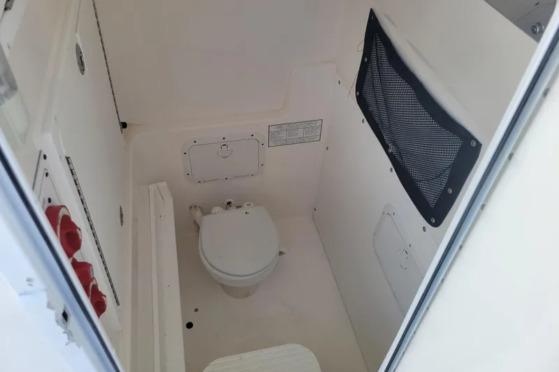 Slide: The Image of 2006 Regulator 29 Forward Seating boat interior with compact marine toilet. - 8