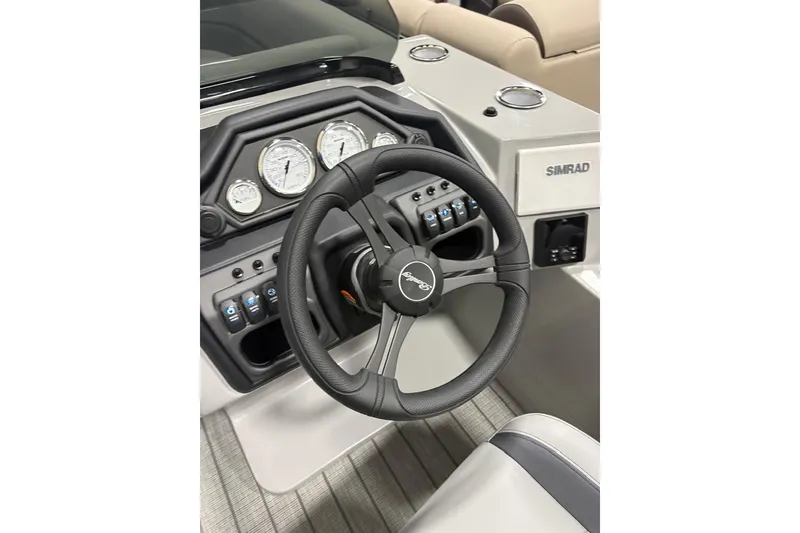 Slide: The Image of 2026 Bentley Pontoons 223 NAVIGATOR dashboard with steering wheel and control panel. - 7
