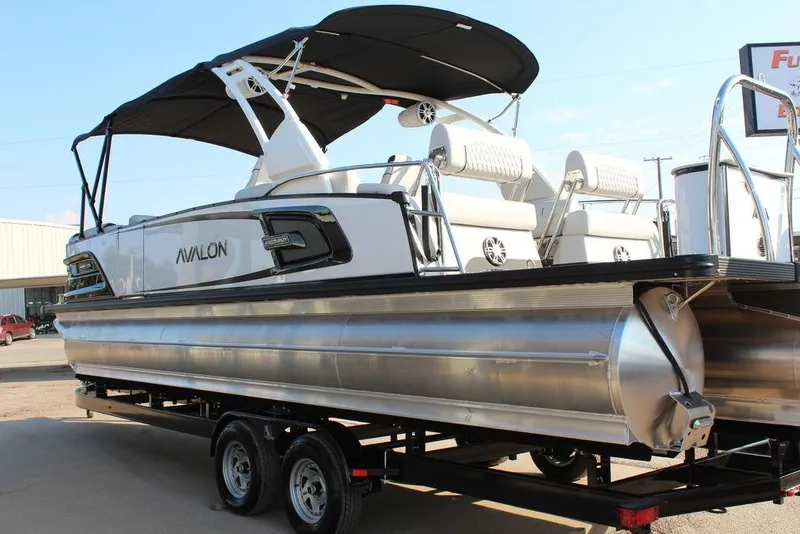 Slide: The Image of 2026 Avalon Excalibur LTD Quad Lounge 25 FT pontoon boat on trailer, featuring sleek design. - 12