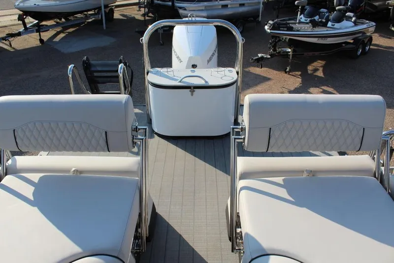 Slide: The Image of 2026 Avalon Excalibur LTD Quad Lounge 25 FT boat interior with plush seating and motor. - 13