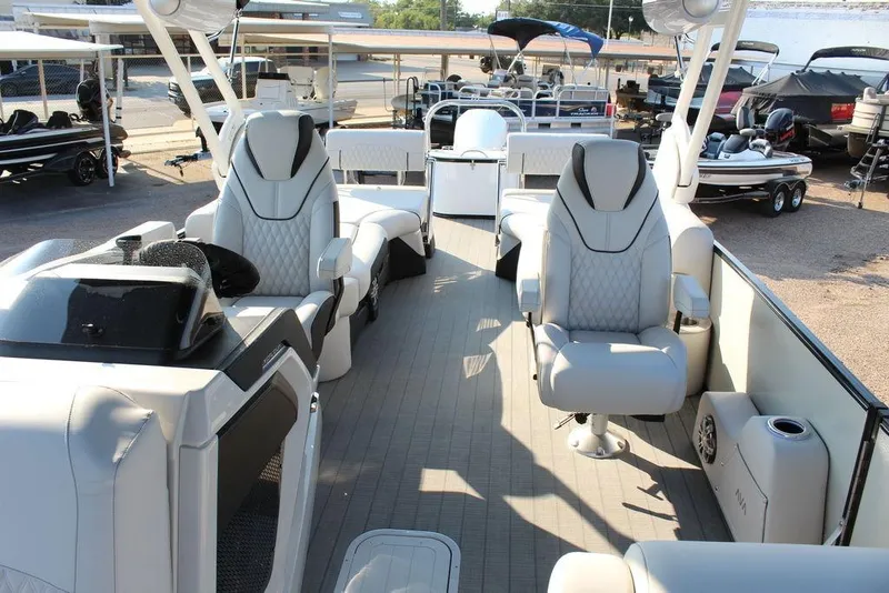 Slide: The Image of 2026 Avalon Excalibur LTD Quad Lounge 25 FT pontoon boat with luxurious seating and modern design. - 16