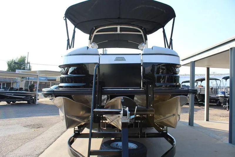 Slide: The Image of 2026 Avalon Excalibur LTD Quad Lounge 25 FT pontoon boat, front view, in a marina setting. - 4