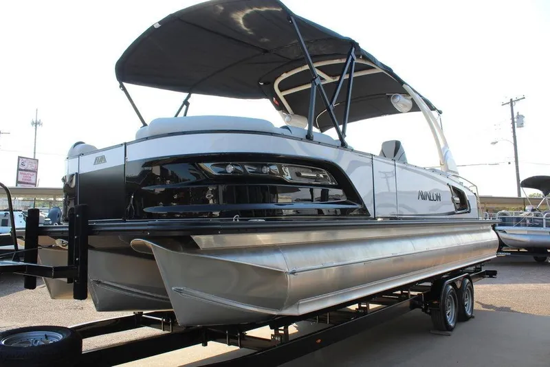Slide: The Image of 2026 Avalon Excalibur LTD Quad Lounge 25 FT pontoon boat on trailer, side view. - 8