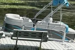 Slide: The Image of 2019 Qwest LS 714 Lanai Cruise pontoon boat docked by a lake. - 1