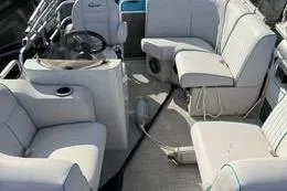 Slide: The Image of 2019 Qwest LS 714 Lanai Cruise boat interior with plush seating and steering console. - 3