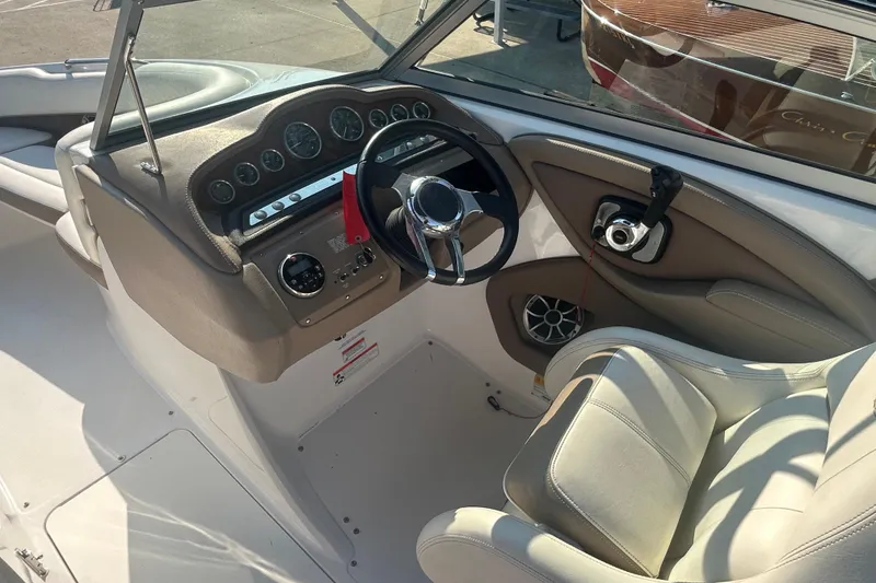 Slide: The Image of Interior of a 2011 Cobalt 242 boat showing steering wheel and dashboard controls. - 10