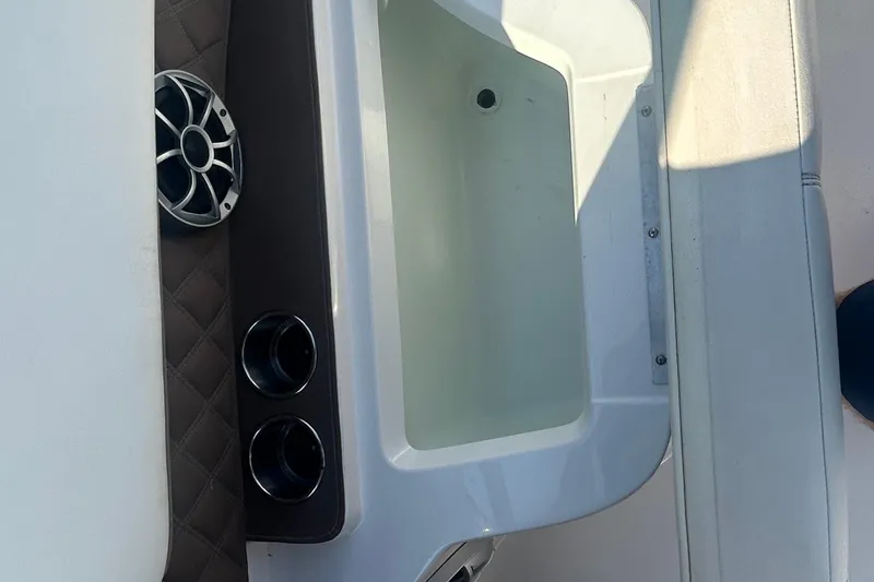 Slide: The Image of 2011 Cobalt 242 boat interior with speaker and cup holders. - 11