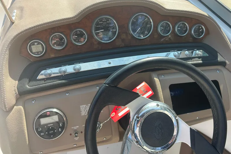 Slide: The Image of Dashboard of a 2011 Cobalt 242 boat with steering wheel and gauges. - 15