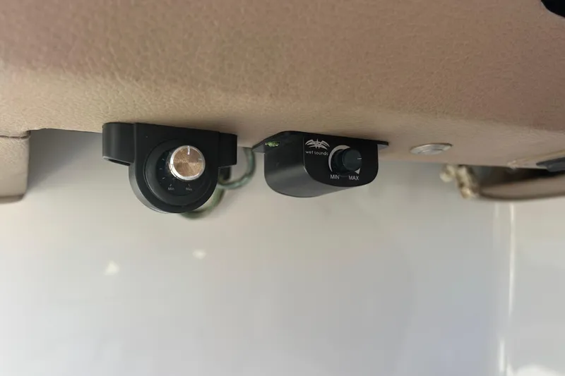 Slide: The Image of Audio control knobs in a 2011 Cobalt 242 boat interior. - 16