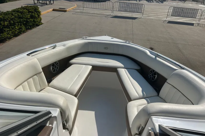 Slide: The Image of 2011 Cobalt 242 boat interior with white leather seating and speakers. - 19
