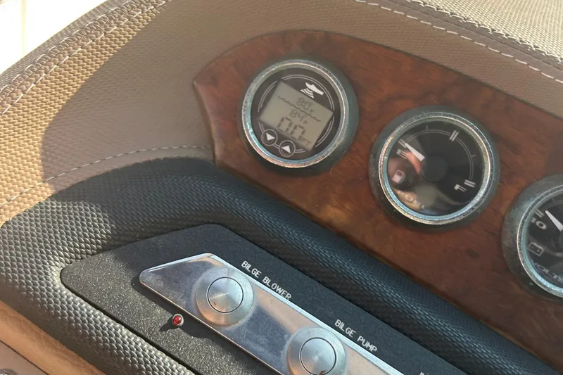 Slide: The Image of Dashboard of a 2011 Cobalt 242 boat with gauges and bilge controls. - 24