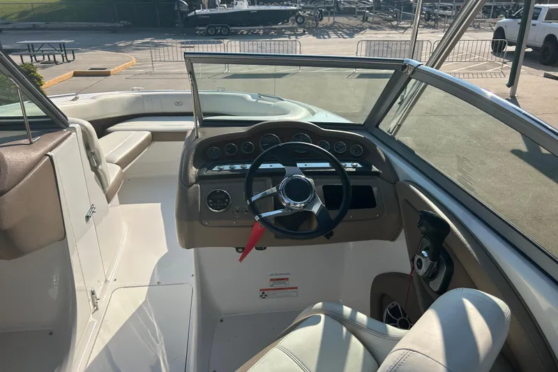 Slide: The Image of Interior view of 2011 Cobalt 242 boat cockpit with steering wheel and dashboard. - 26