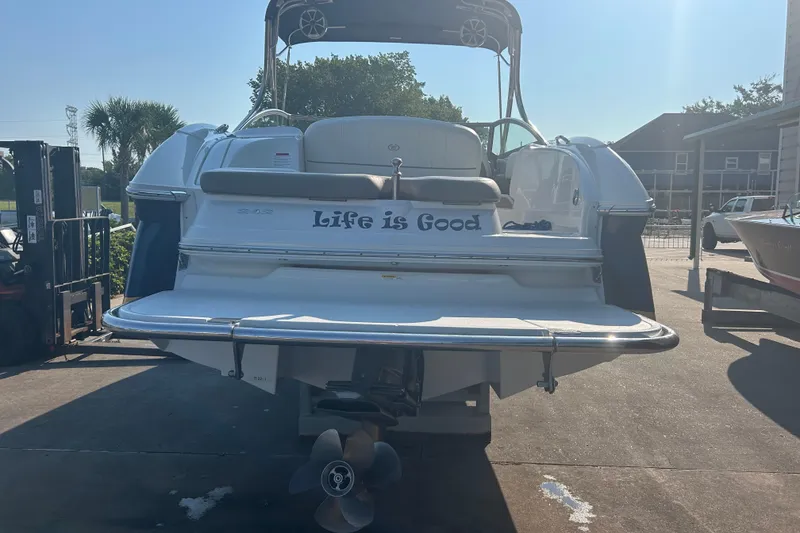 Slide: The Image of 2011 Cobalt 242 boat with "Life is Good" text on the back, parked outdoors. - 3