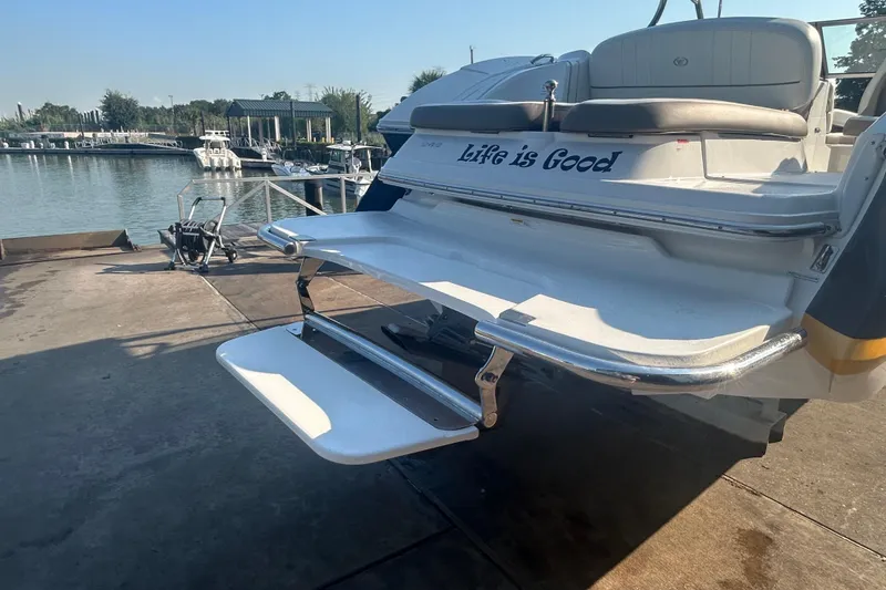 Slide: The Image of 2011 Cobalt 242 boat with "Life is Good" text, docked near a marina. - 6