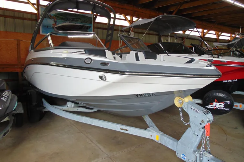 Slide: The Image of 2020 Yamaha Boats 195S in storage, white hull, on trailer, under shelter. - 1