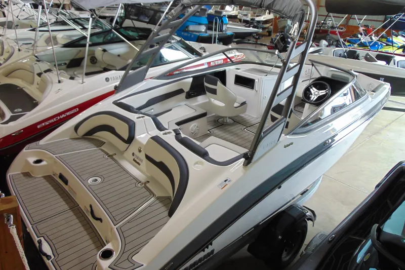Slide: The Image of 2020 Yamaha Boats 195S, sleek design, spacious interior, displayed in showroom. - 2