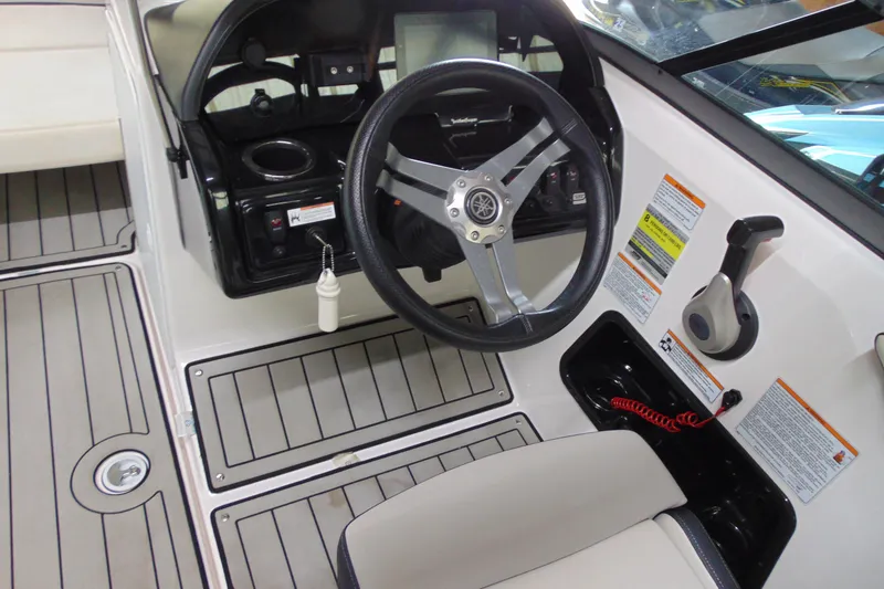 Slide: The Image of 2020 Yamaha Boats 195S steering console with controls and dashboard. - 6