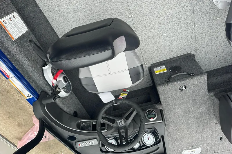 Slide: The Image of 2025 Crestliner 1750 Hawk boat interior with steering wheel and seat. - 16