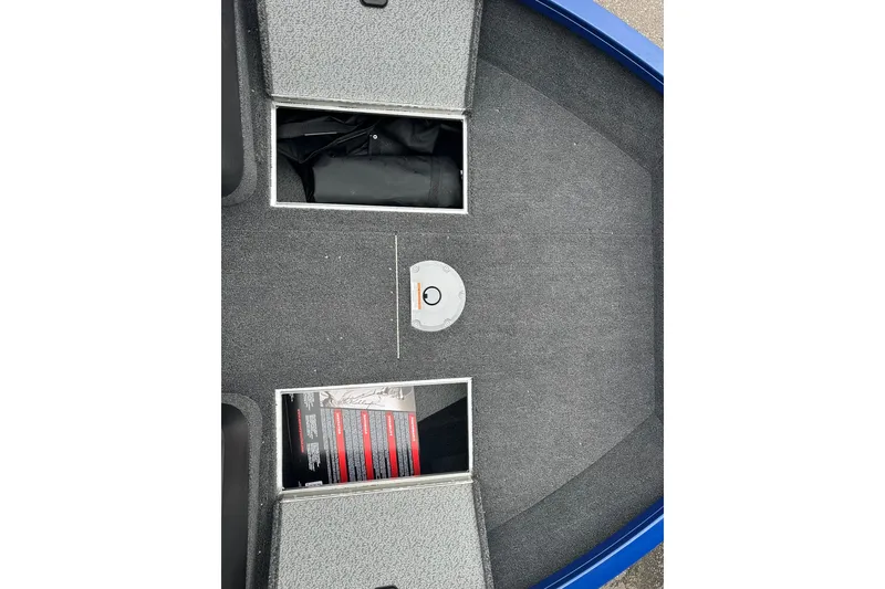 Slide: The Image of 2025 Crestliner 1750 Hawk boat interior with storage compartments and carpeted flooring. - 20