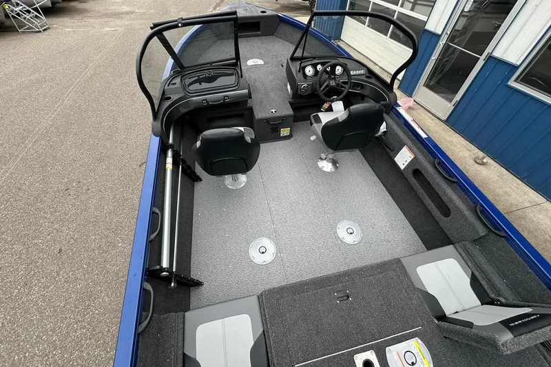 Slide: The Image of 2025 Crestliner 1750 Hawk boat interior with dual seats and steering console. - 22