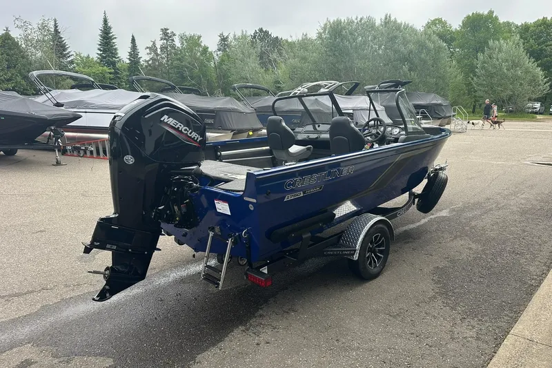 Slide: The Image of 2025 Crestliner 1750 Hawk boat with Mercury engine, parked outdoors. - 5